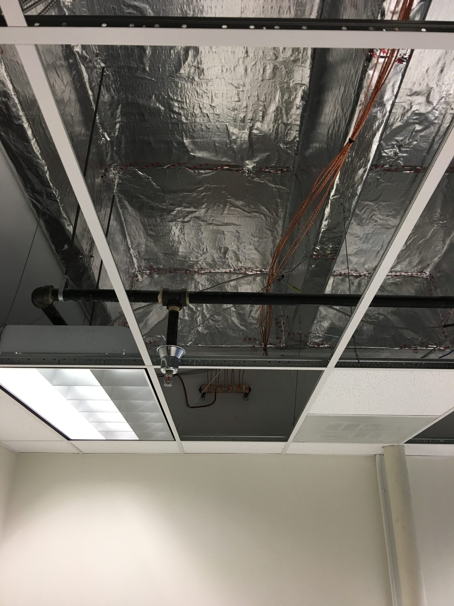 Reflective shielding coordinated above a suspended ceiling